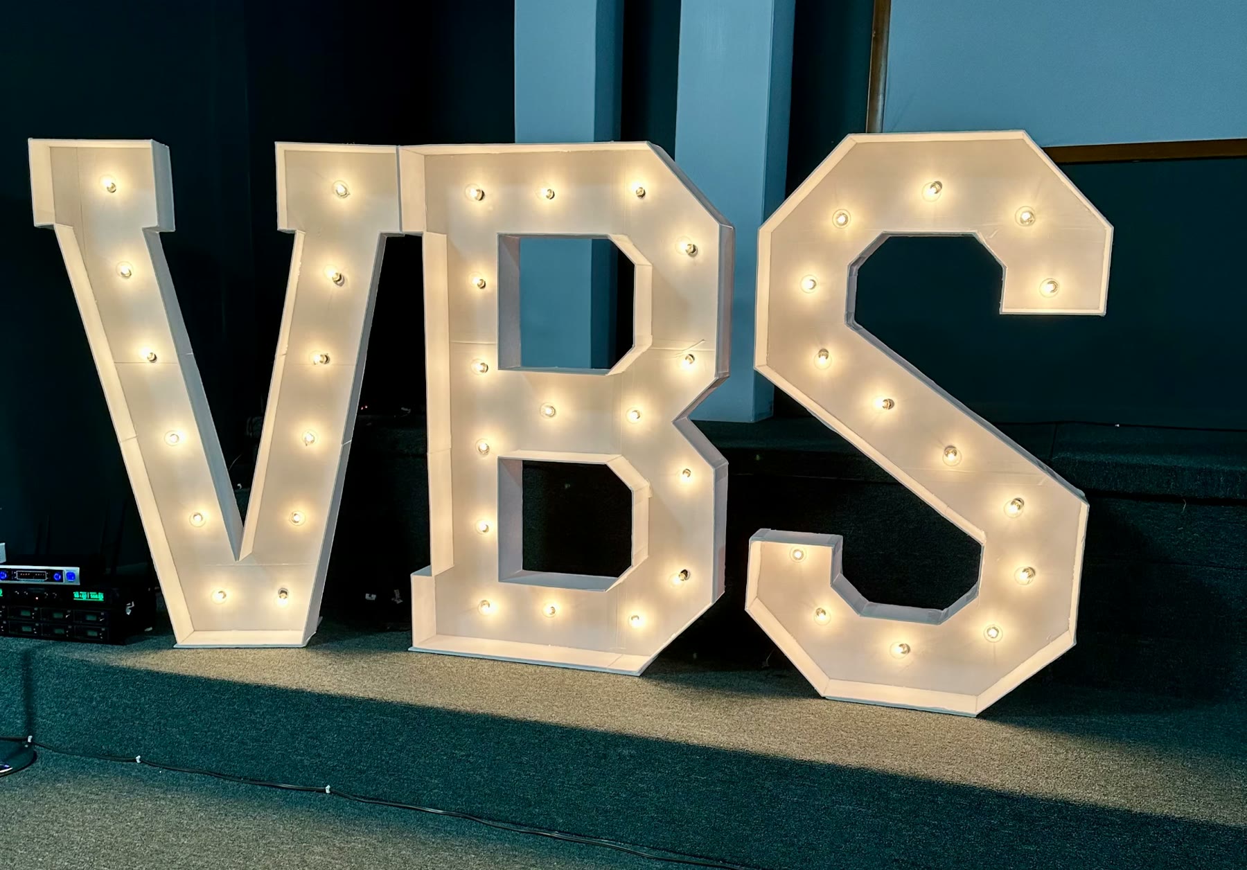 Lighted VBS marquee letters on a stage